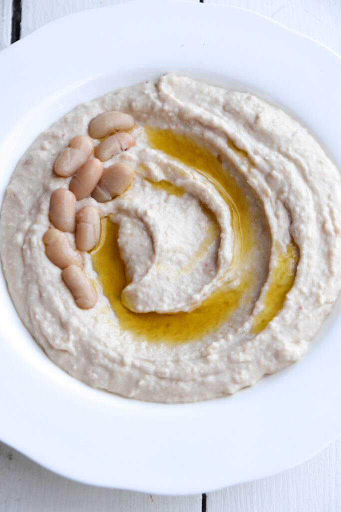 up close of white bean hummus in a bowl