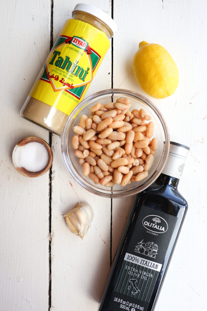 ingredients for white bean hummus on a white background