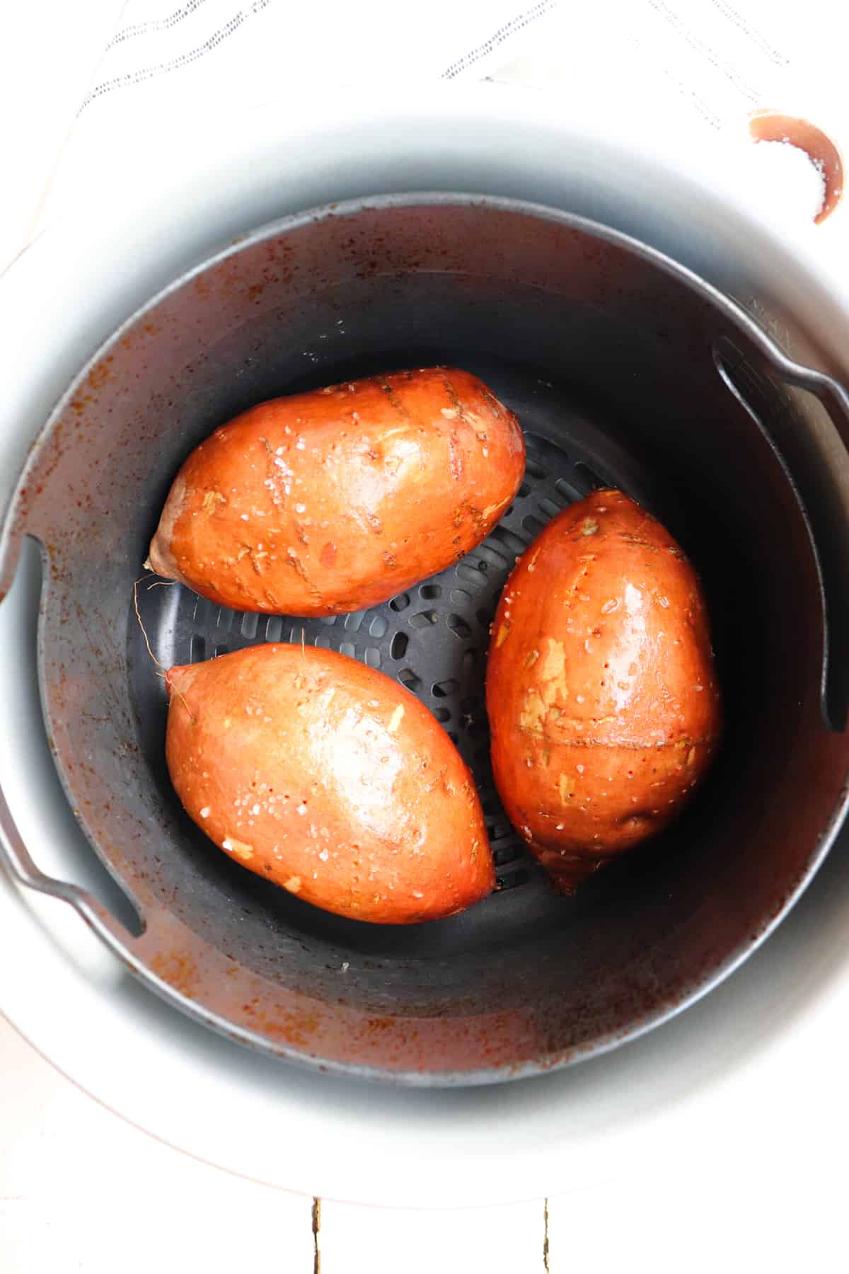 3 sweet potatoes in air fryer basket