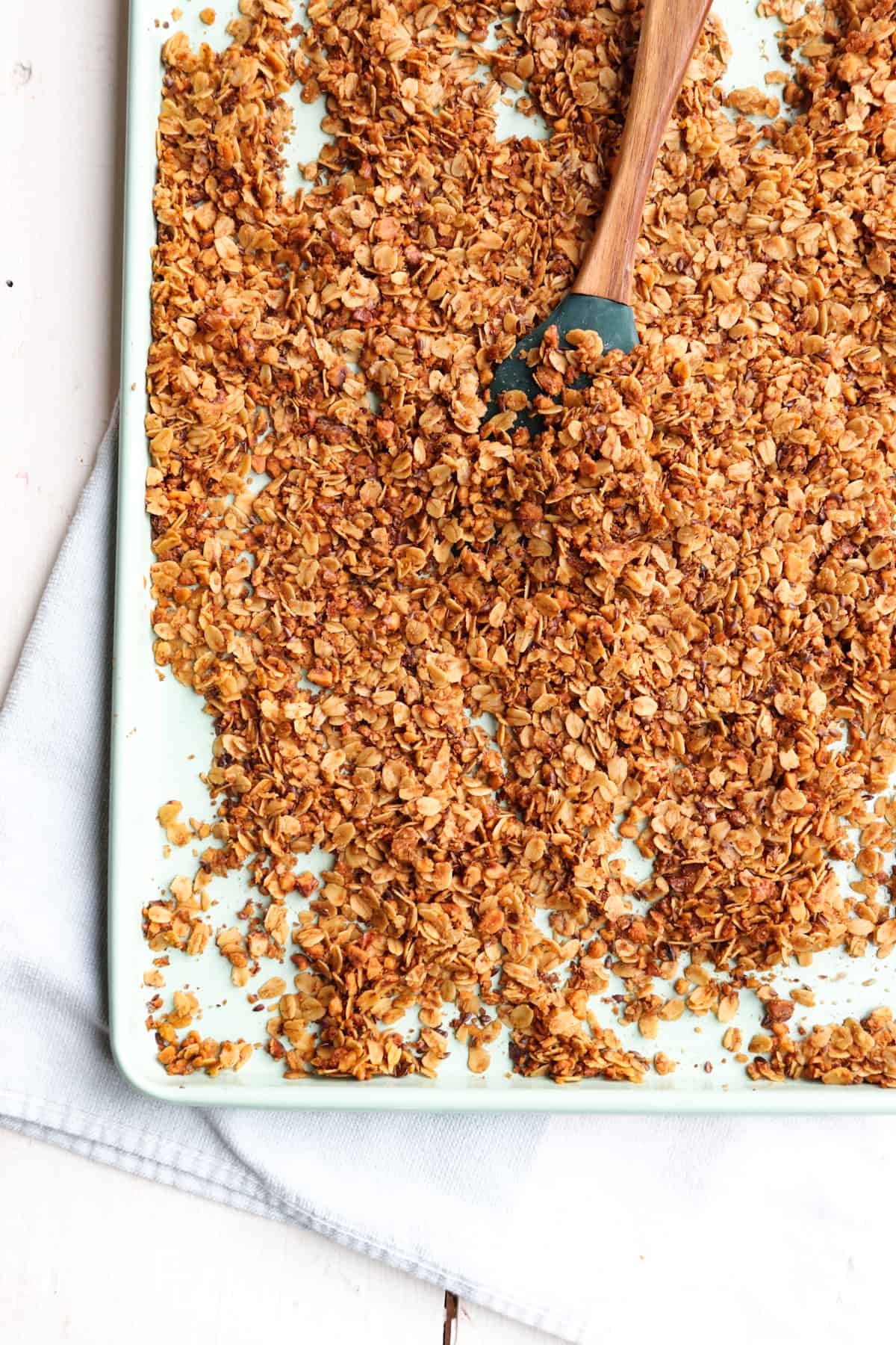 finished granola being flipped with a spatula