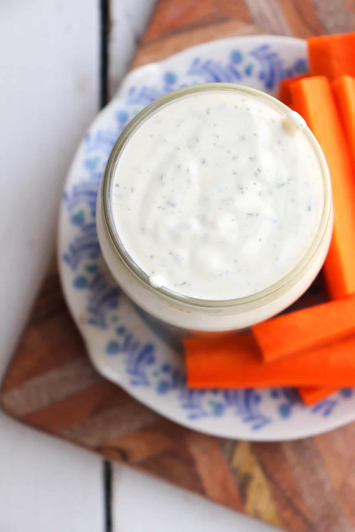 ranch in a glass jar with carrot sticks.