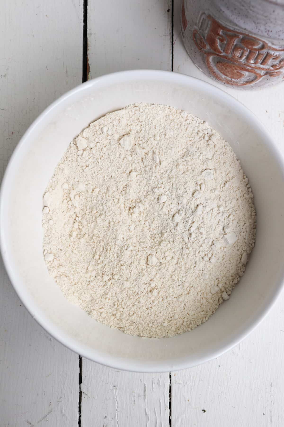 flour and butter combined in a white bowl.