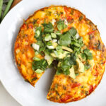 plated mexican frittata with herbs on top.