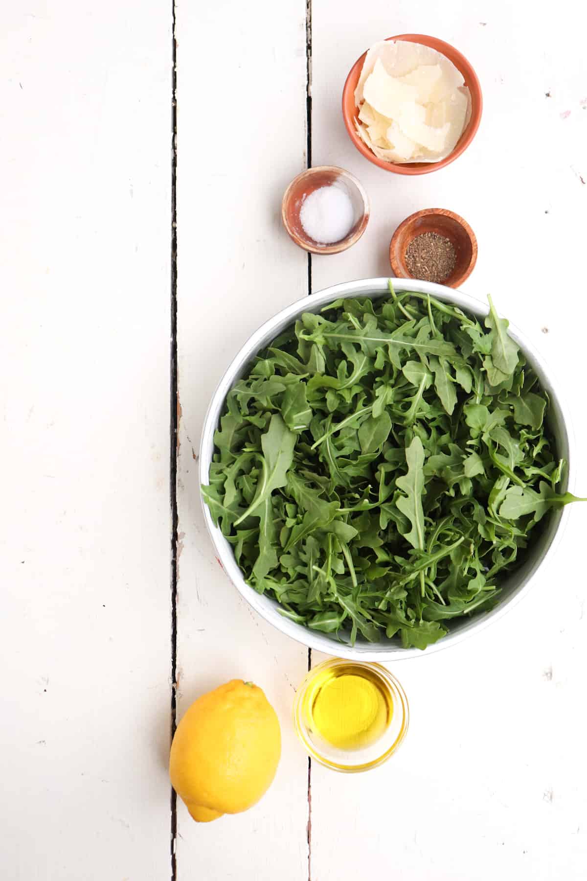 ingredients for the rocca salad on a white background.