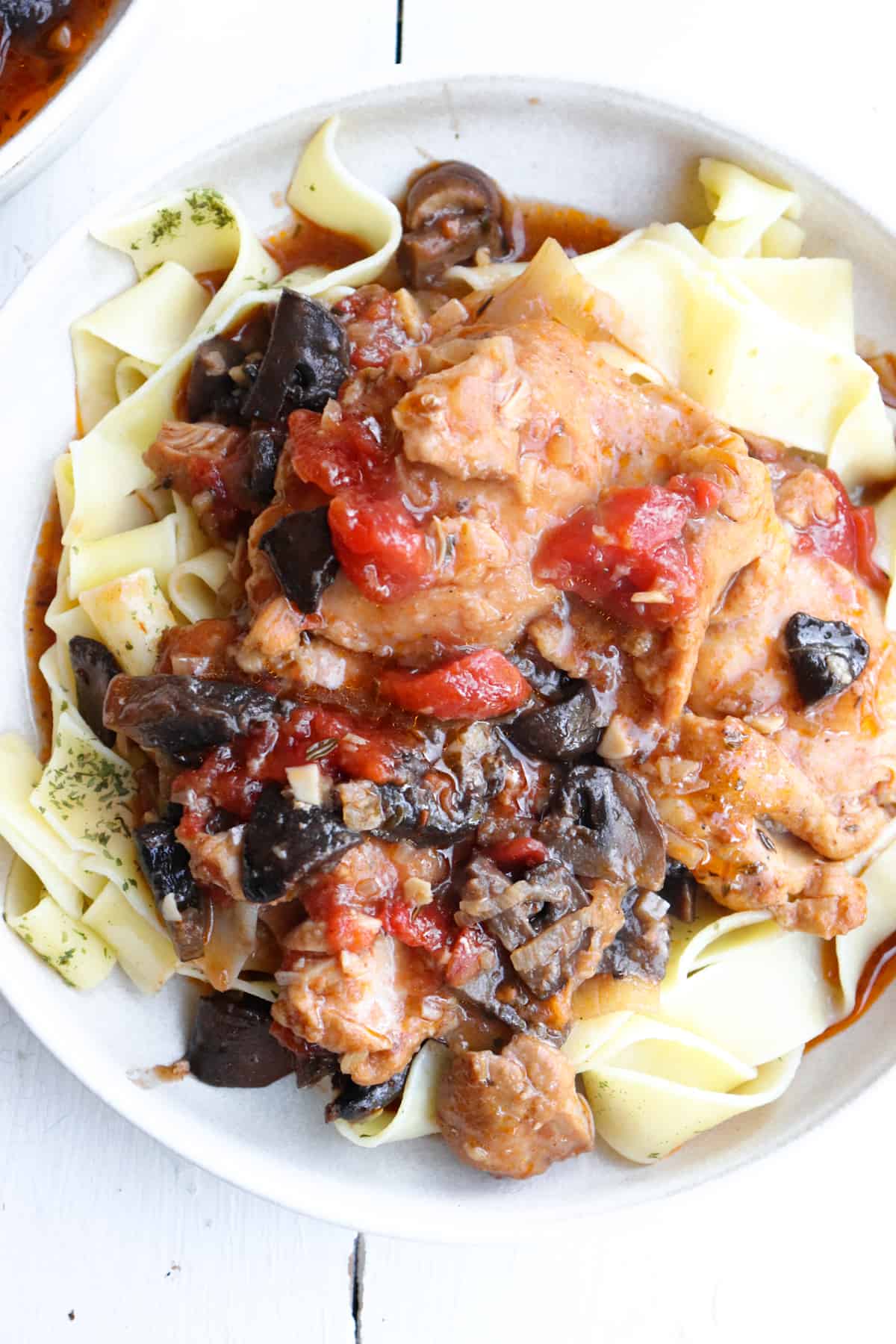 chicken chasseur on a bed of pappardelle.