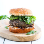 finished boursin mushroom burger on a wooden platter.