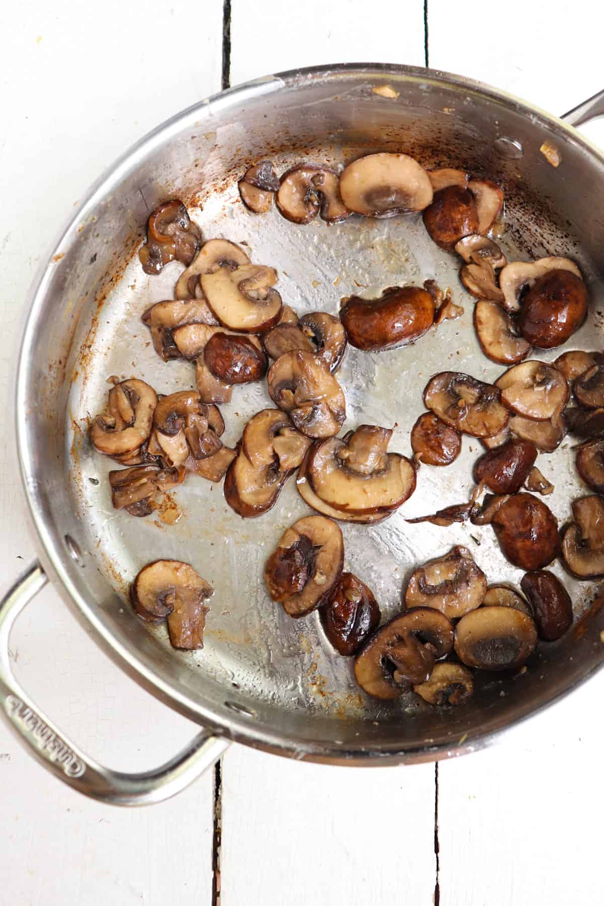 sauteed cremini mushrooms in a skillet.