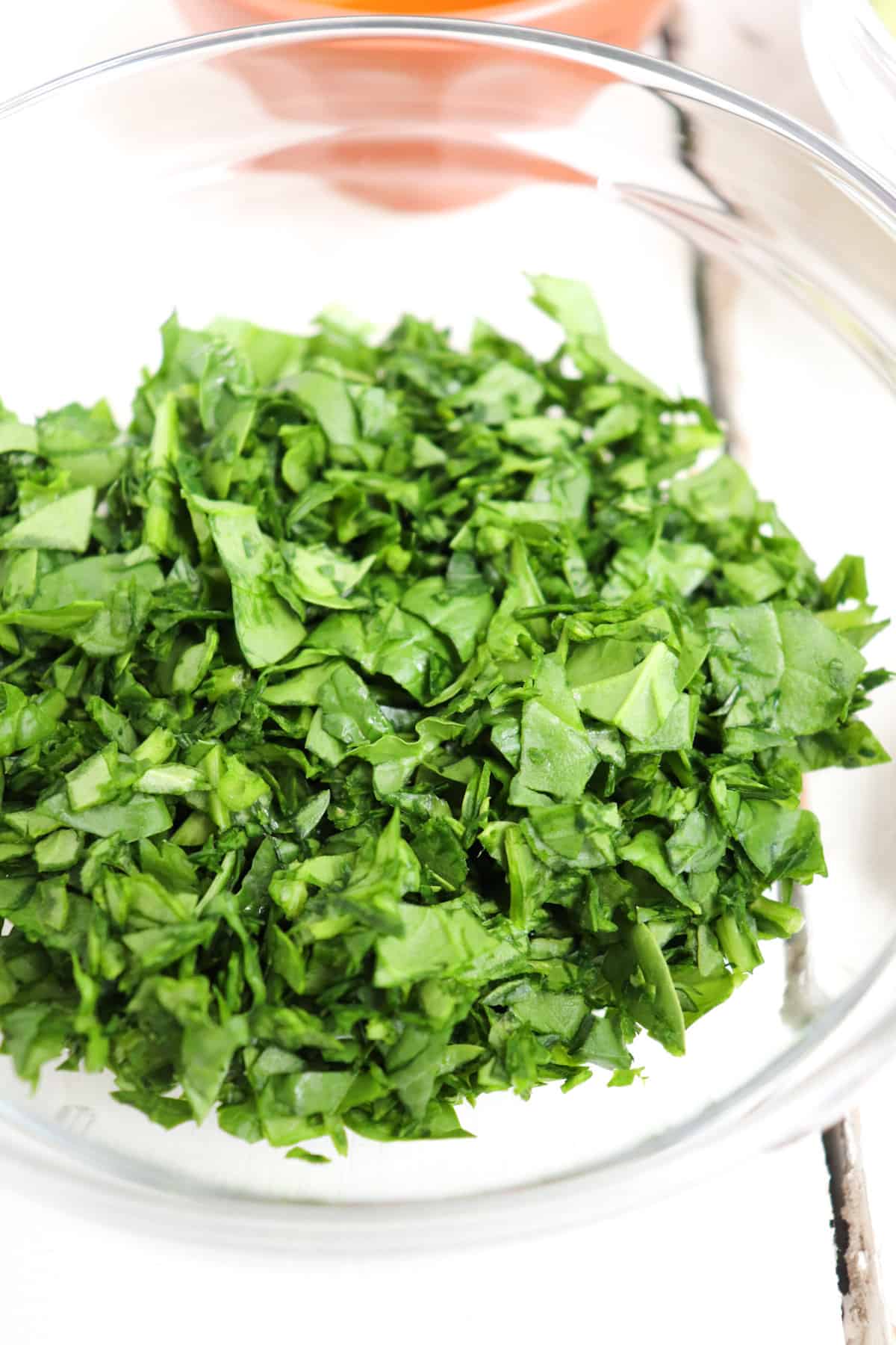 finely chopped spinach in a clear bowl.