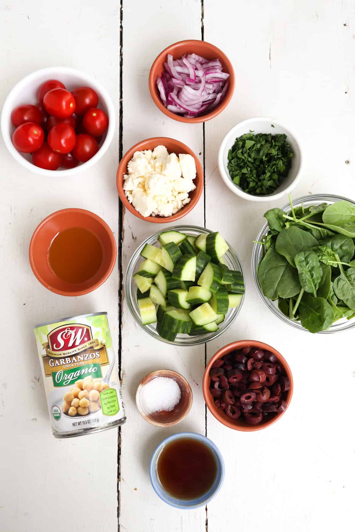 greek cucumber salad ingredients on a white background.