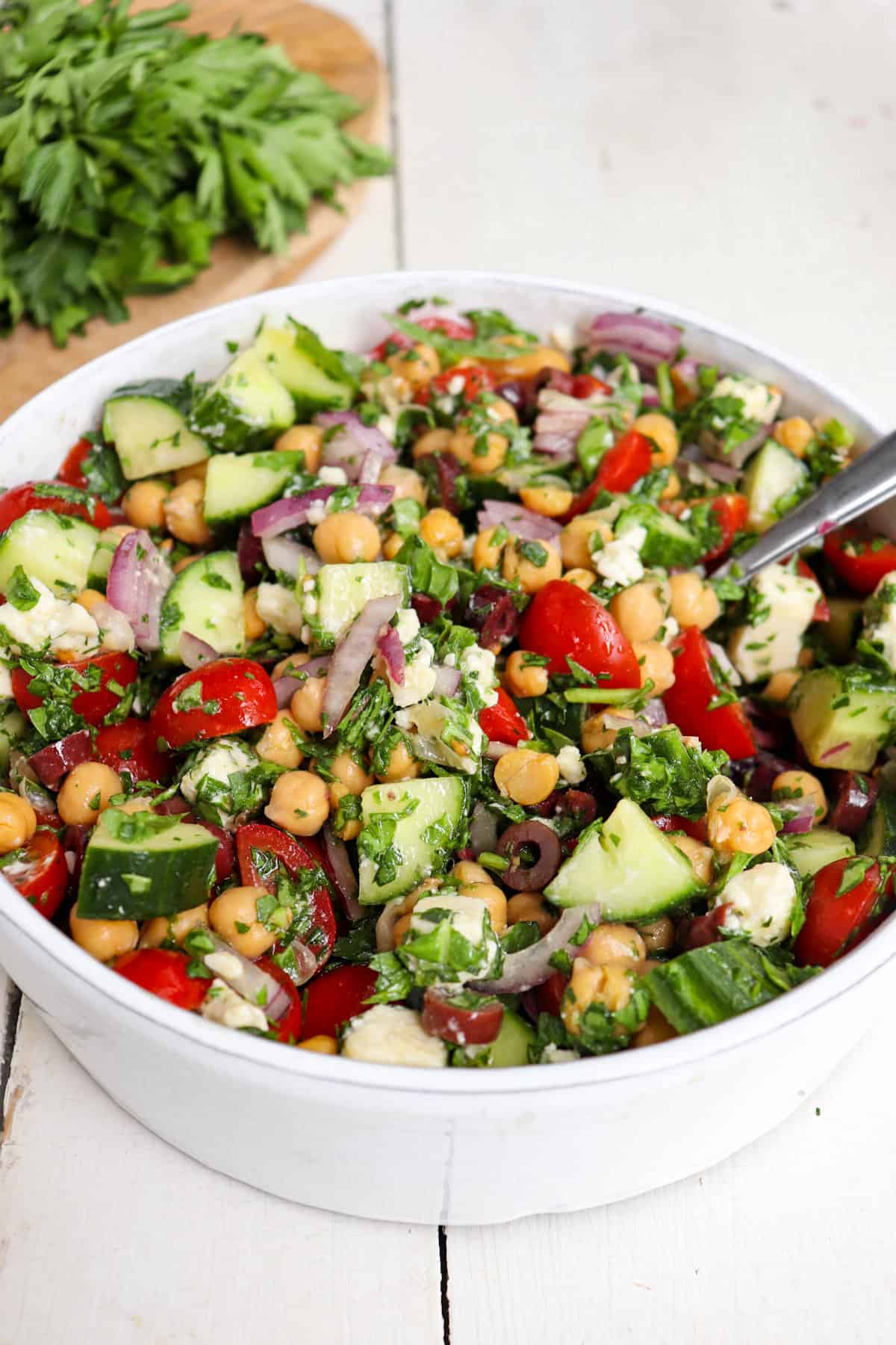 greek cucumber salad in a white bowl.