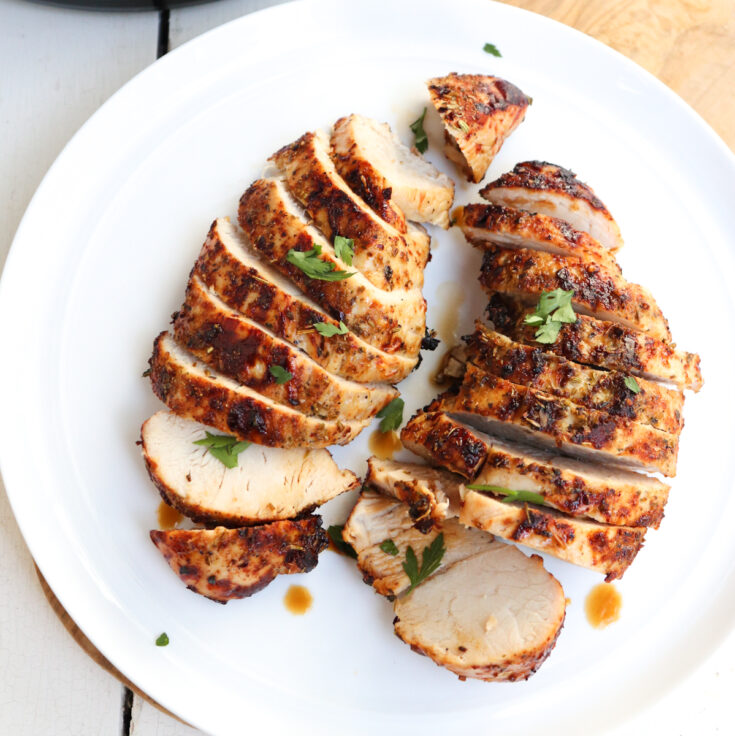 sliced turkey tenderloins garnished with parsley.