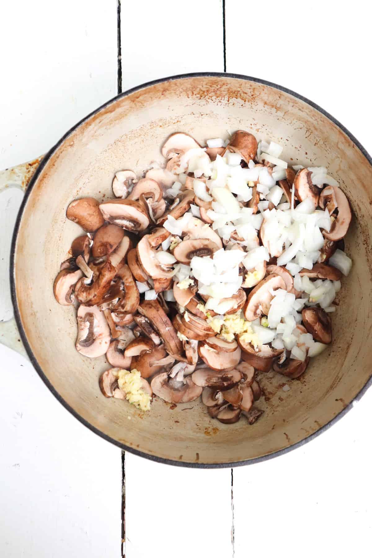 mushrooms and onions added to skillet.