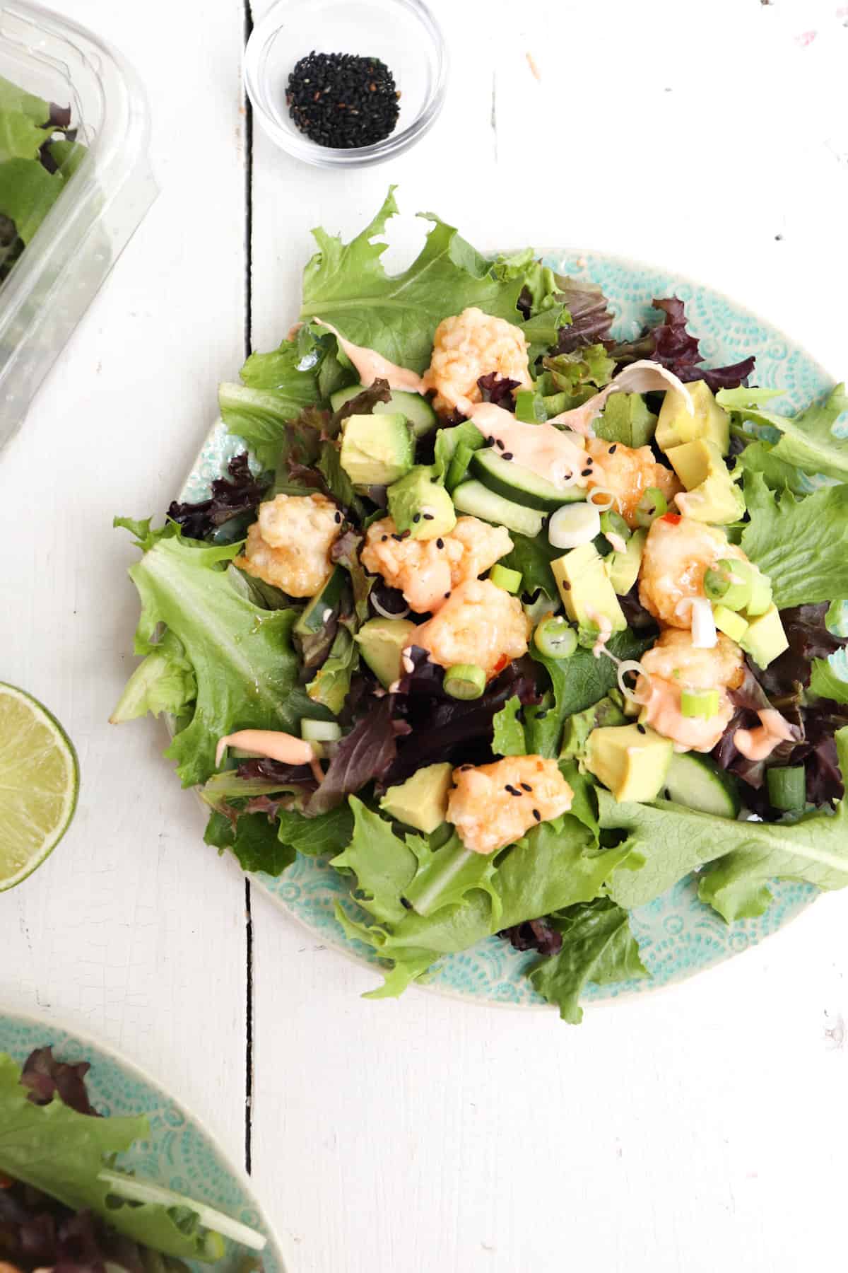 bang bang shrimp salad on a white table.