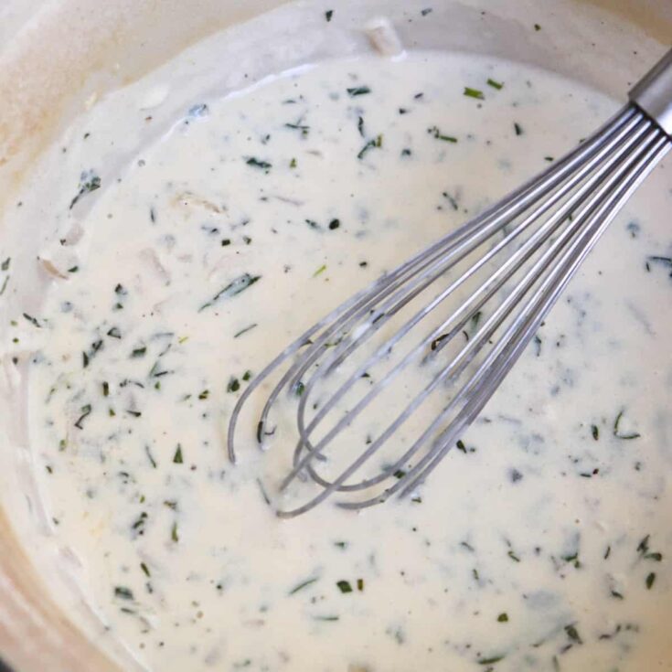 tarragon cream sauce with a whisk.