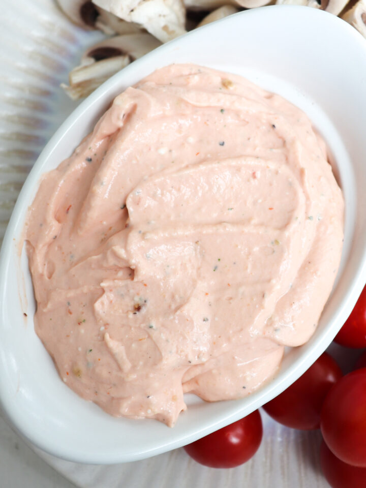 up close of cream cheese dip in a white dish.