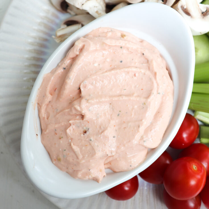up close of cream cheese dip in a white dish.