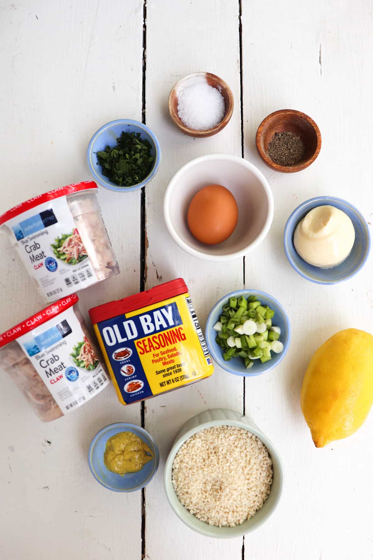 ingredients for air fryer crab cakes on a white table.