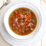 overhead of bowl of soup with a decorative spoon to the side.