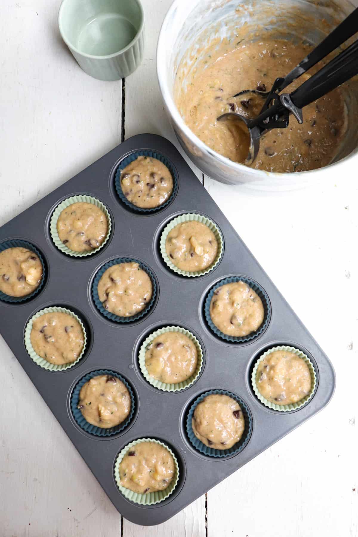 cupcake tin with silicone cupcake liners filled with muffin batter.