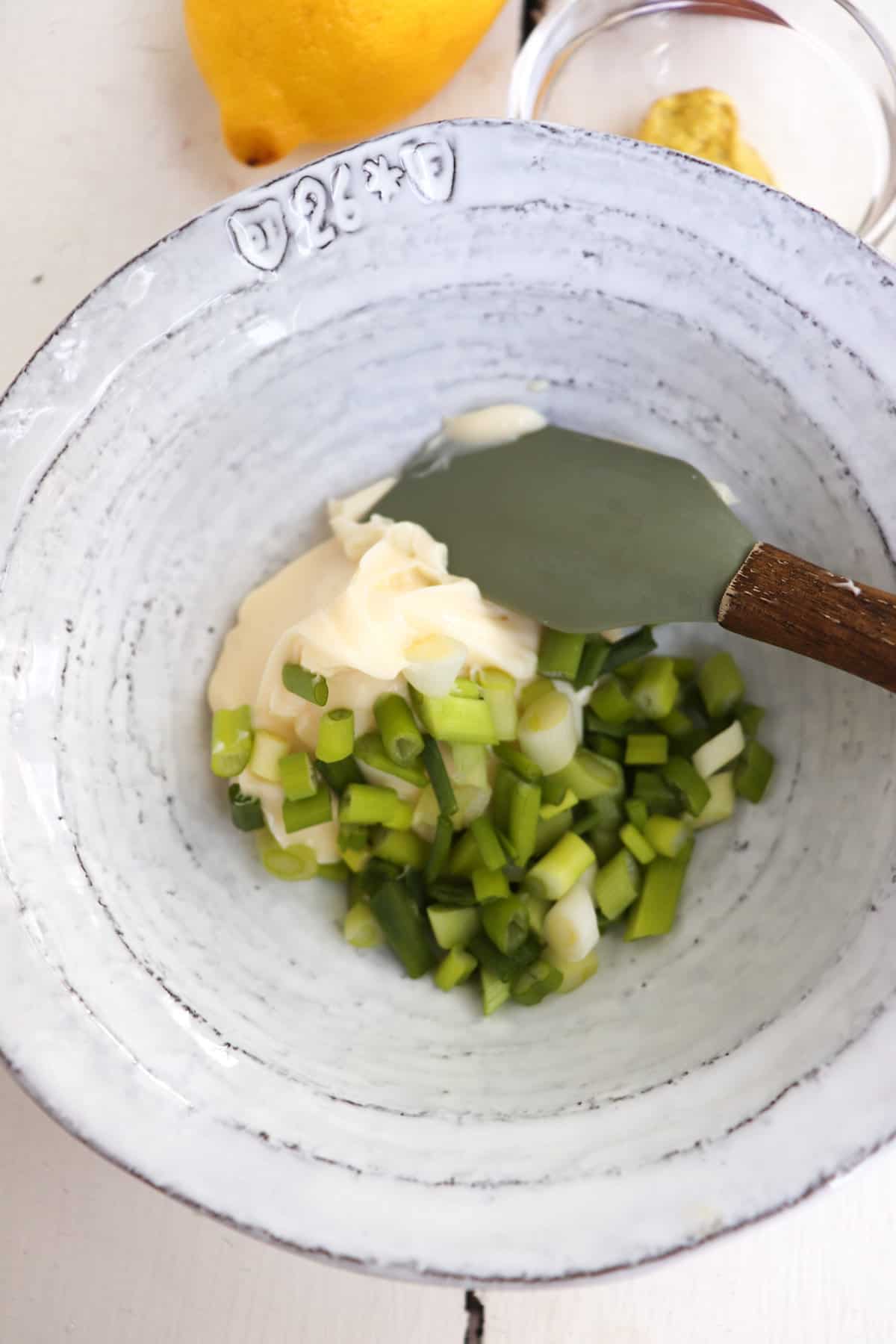 mayo and herbs in a small white bowl.