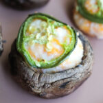 close up shot of cream cheese and jalapeno stuffed mushroom.