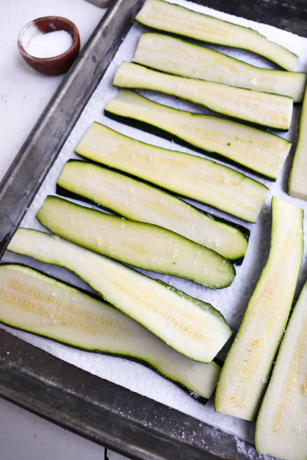sliced zucchini on a baking sheet.