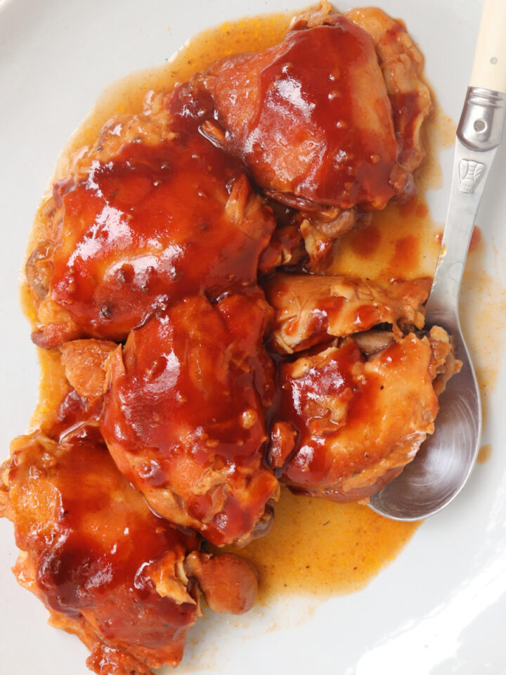 barbecue chicken thighs on a platter.