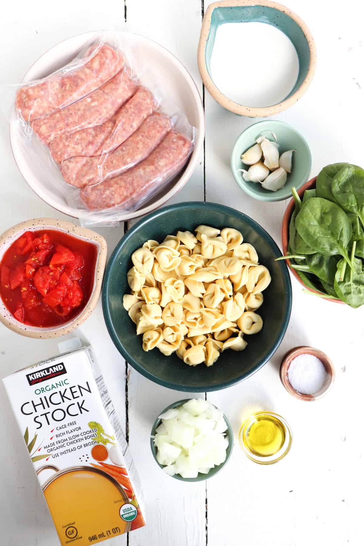 ingredients for instant pot tortellini soup on a white background.