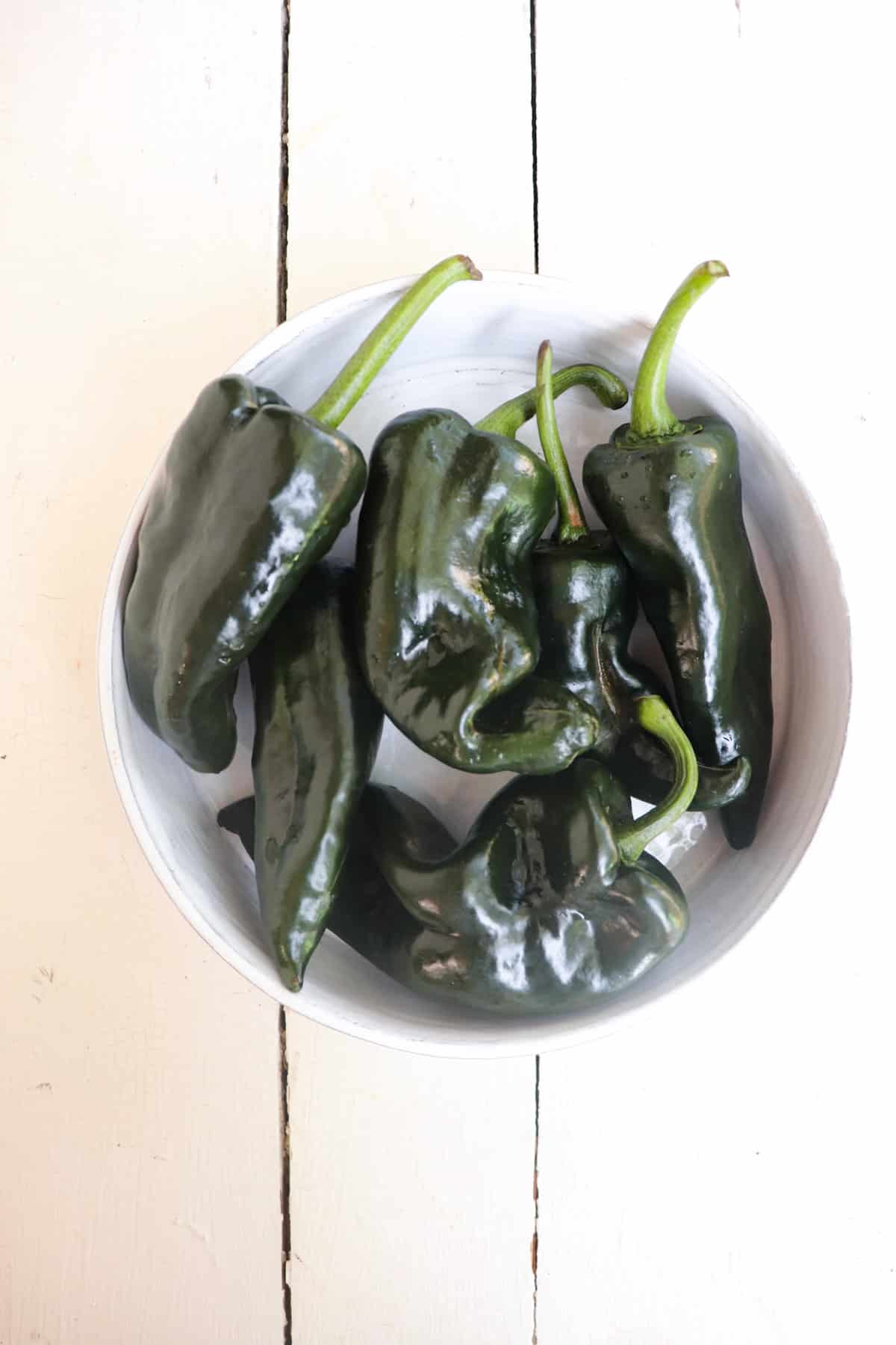 whole peppers in a white serving bowl.