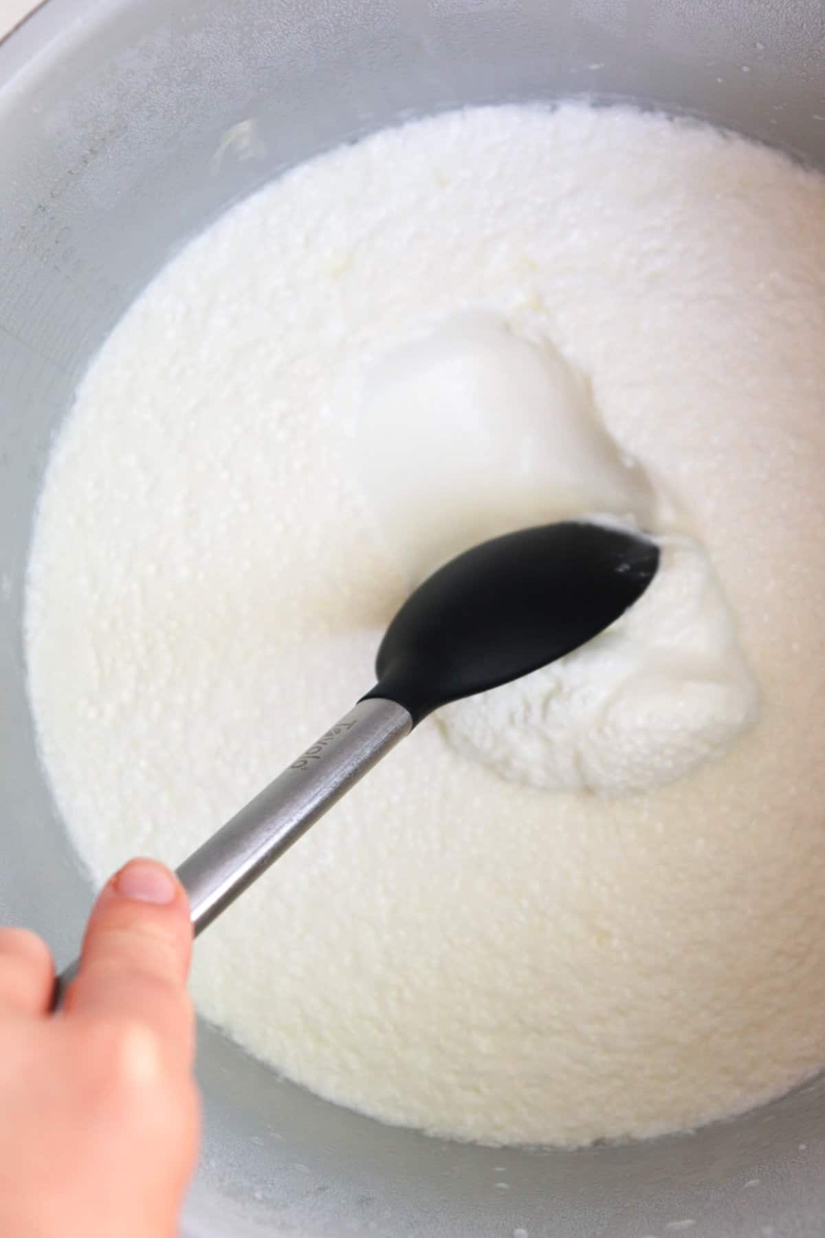 spoon showing consistency of yogurt in the ninja foodi.