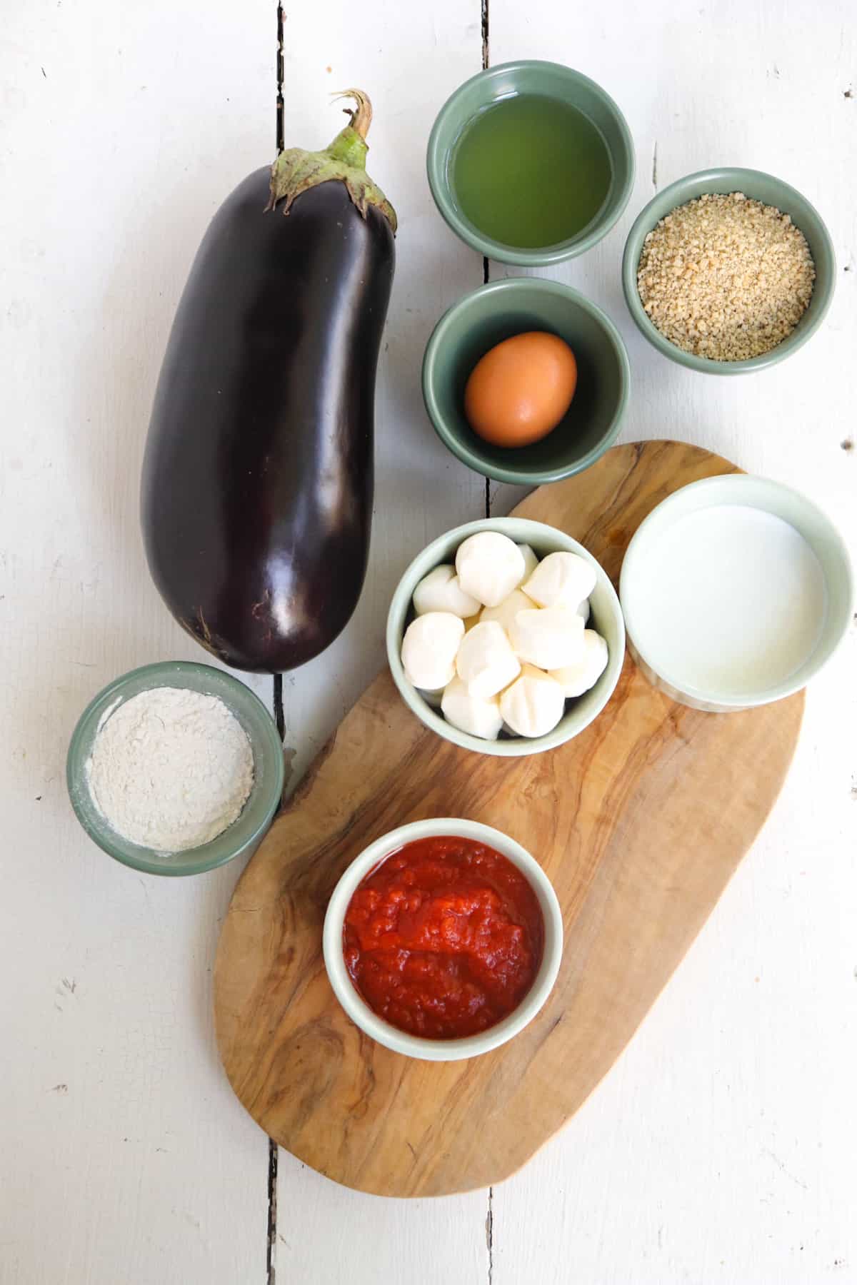 ingredients for olive garden eggplant parmesan on a white background.