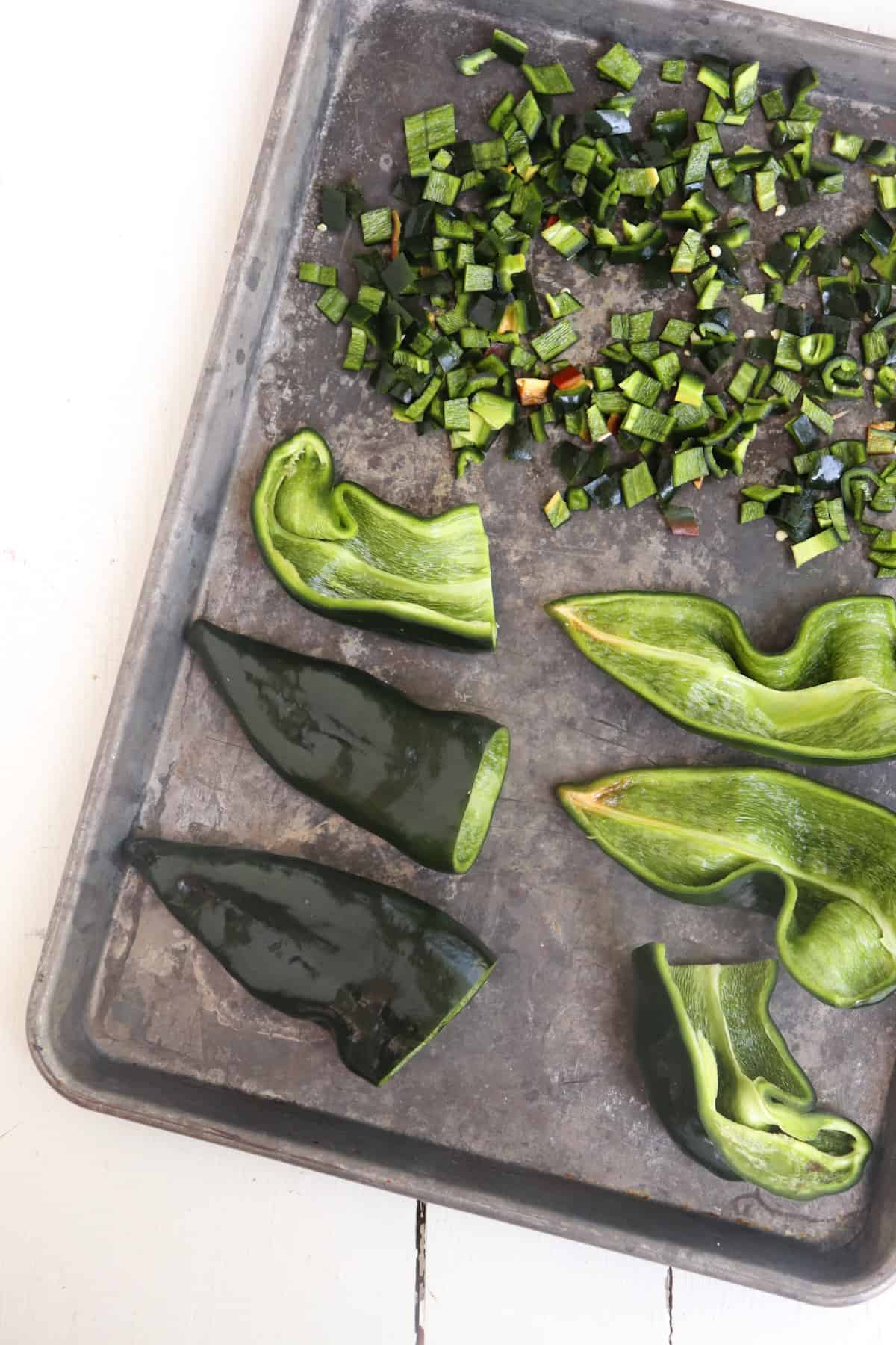 poblanos sliced different ways on baking sheet.