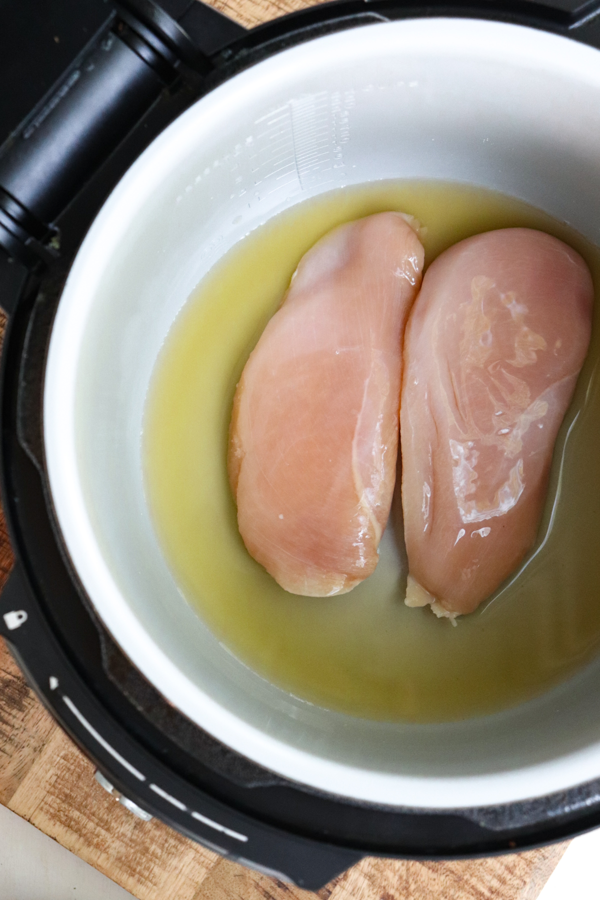 broth and chicken in instant pot.