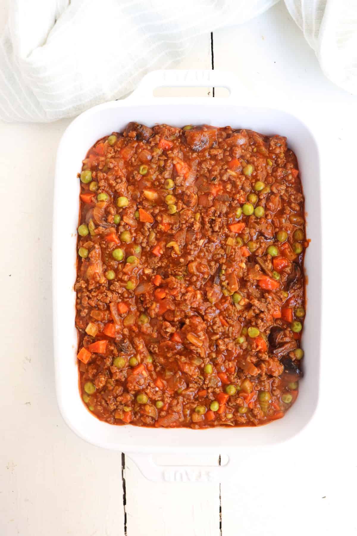 deer meat gravy mixture added to casserole dish.