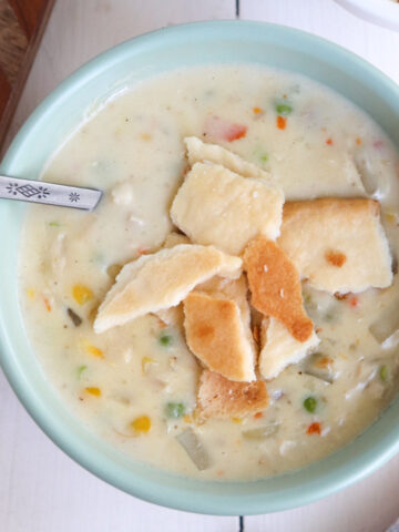 overhead shot of bowl full of potbelly chicken pot pie soup with pie crust on top.