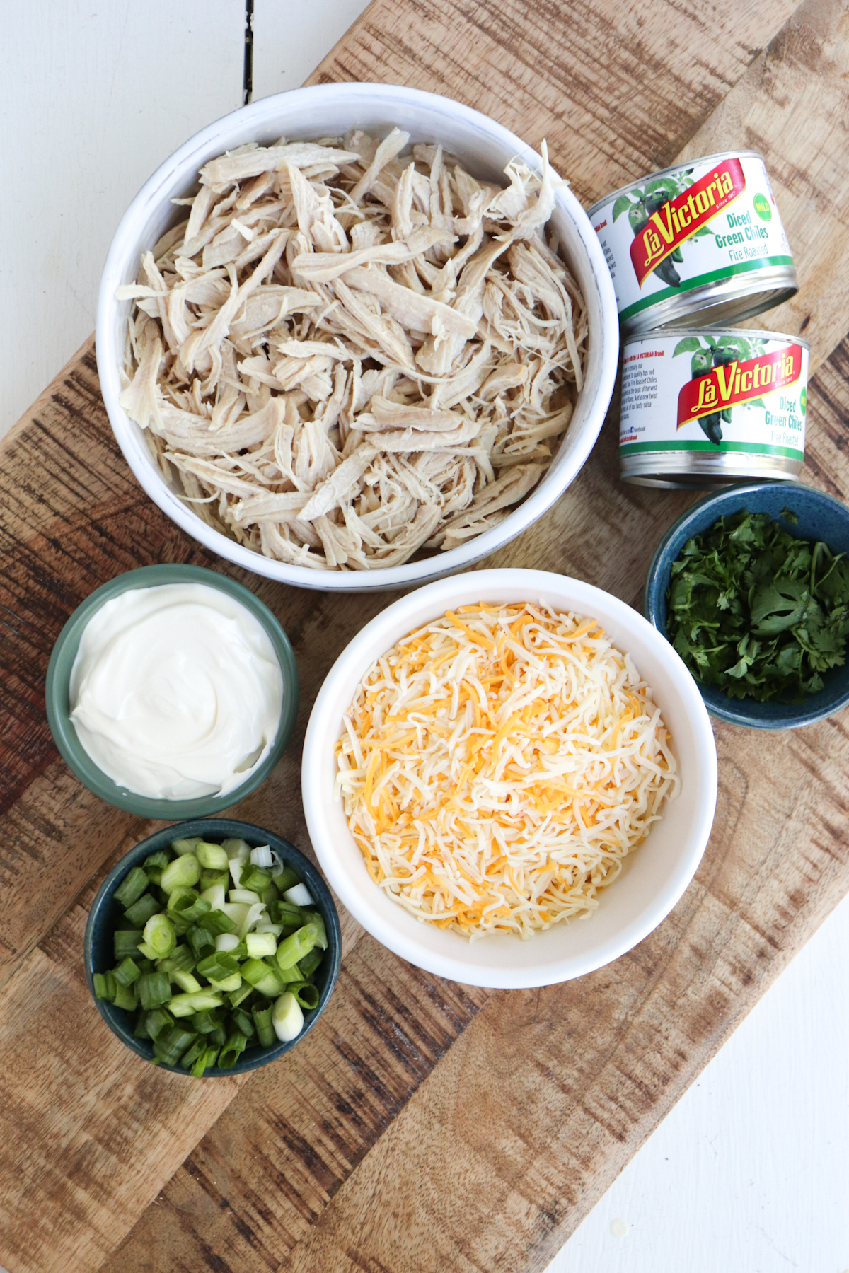 shredded chicken filling ingredients on a wooden background.