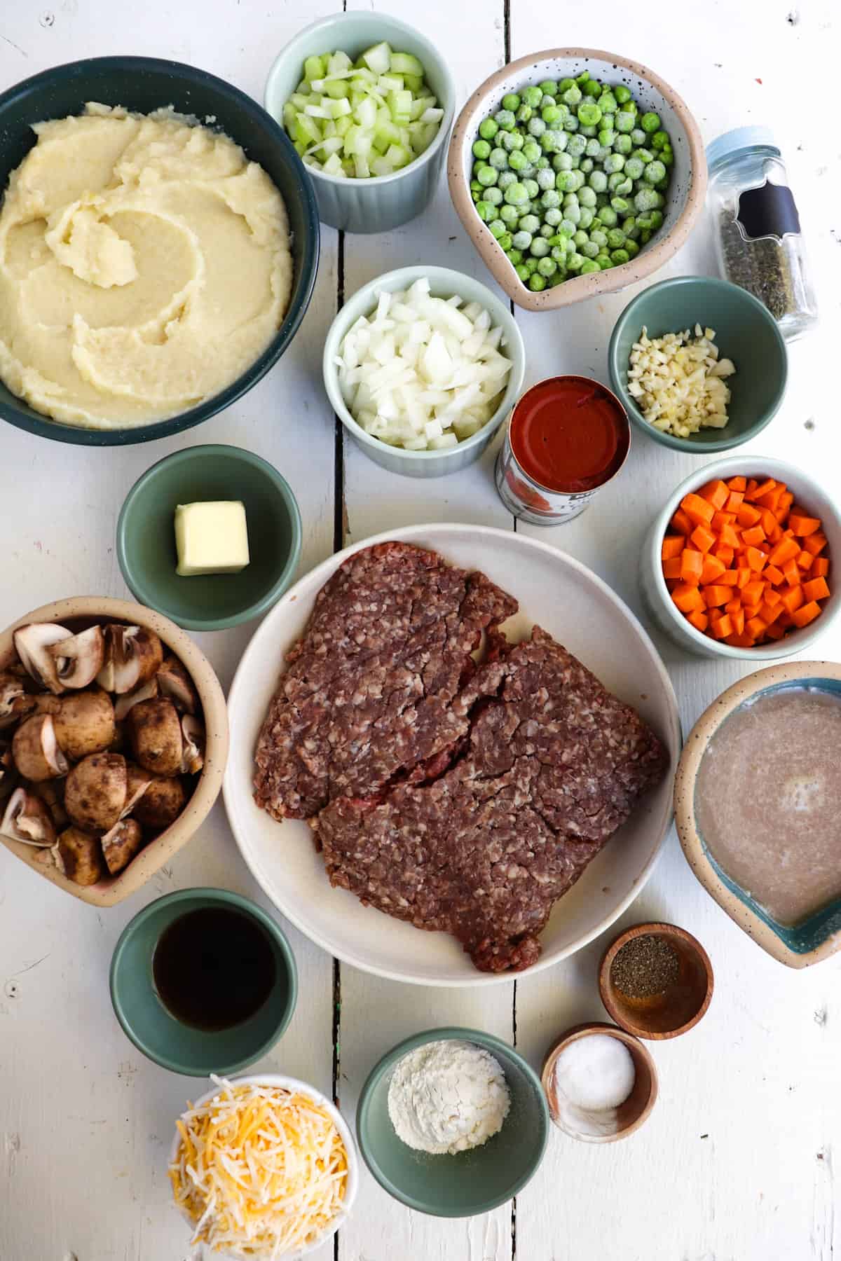 venison shepherd's pie ingredients on a white table.