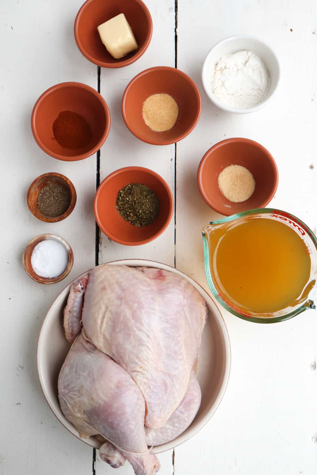 ingredients for ninja foodi whole chicken on a white background.