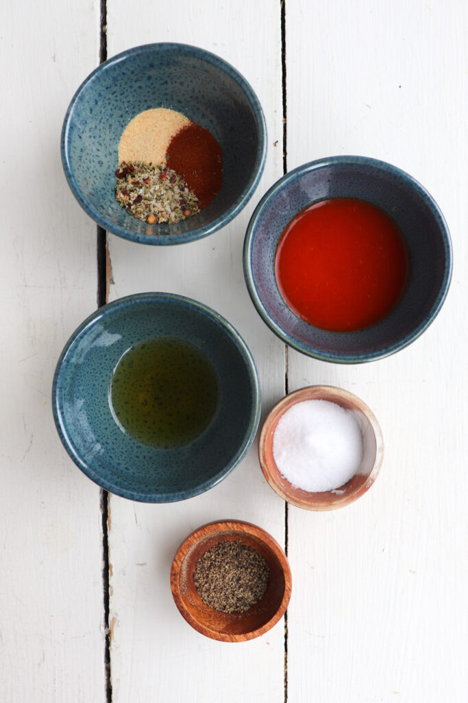 ingredients for chicken marinade in little bowls.
