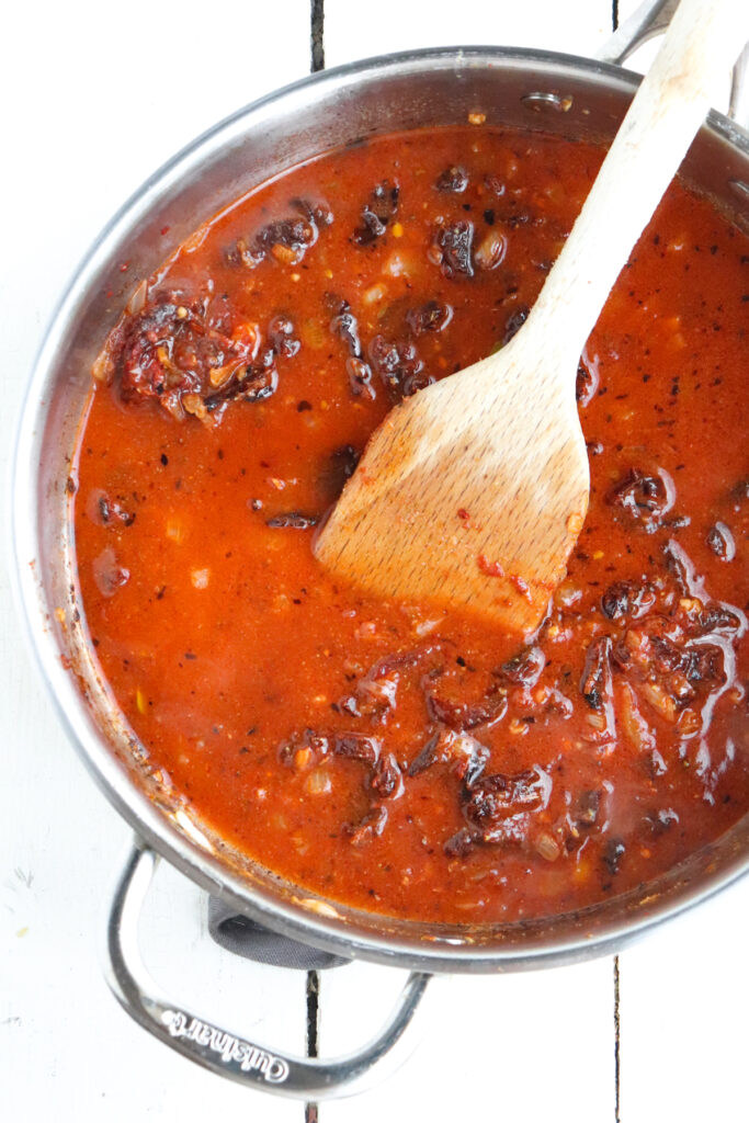 broth added to tomatoes and aromatics.