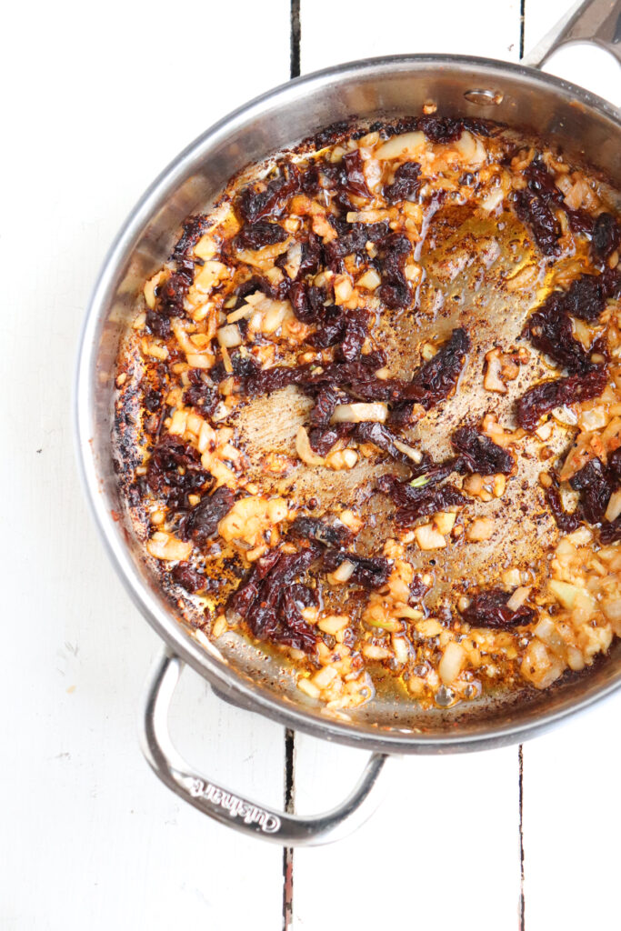 onions, garlic, and sundried tomatoes in a skillet.