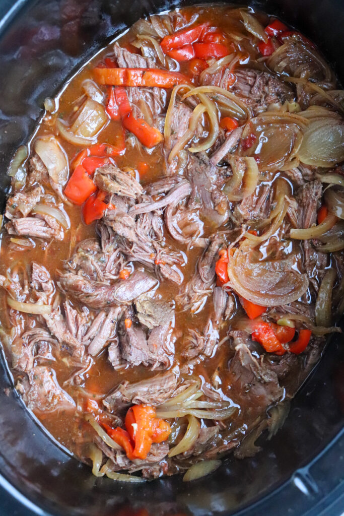 shredded venison with peppers and onions in slow cooker.