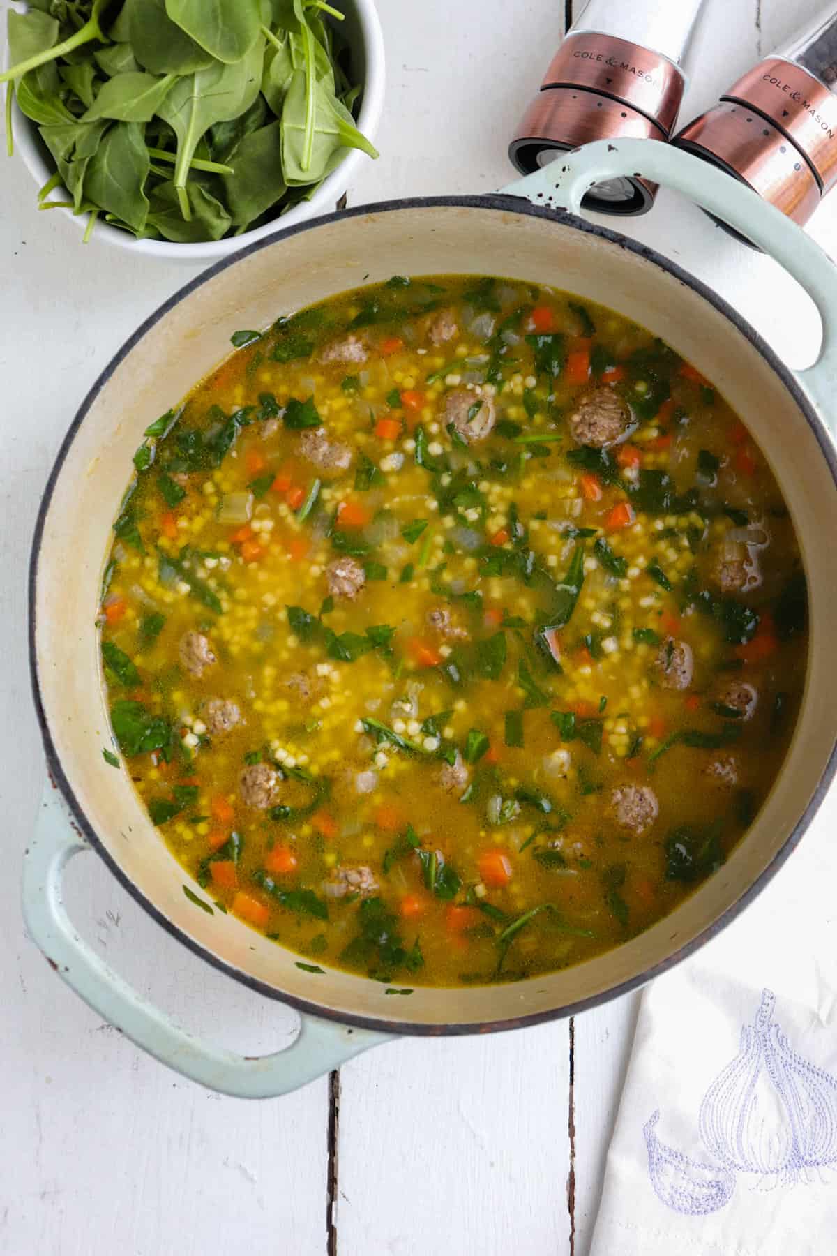 dutch oven pot full of italian wedding soup with veggies.