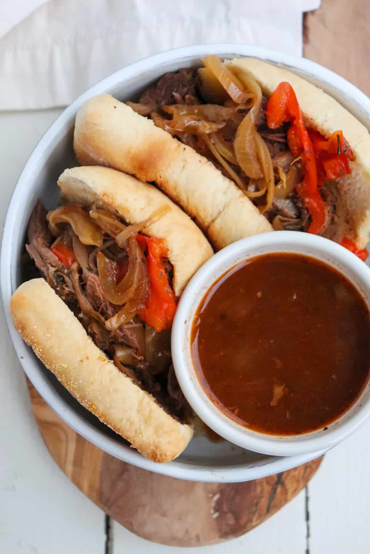 shredded venison on french rolls with gravy on the side.