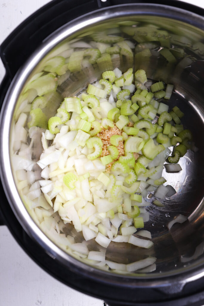 onions, garlic, and celery in instant pot.