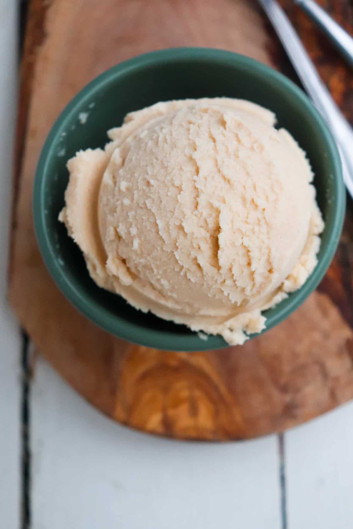 scoop of ninja creami peanut butter ice cream in a green bowl 