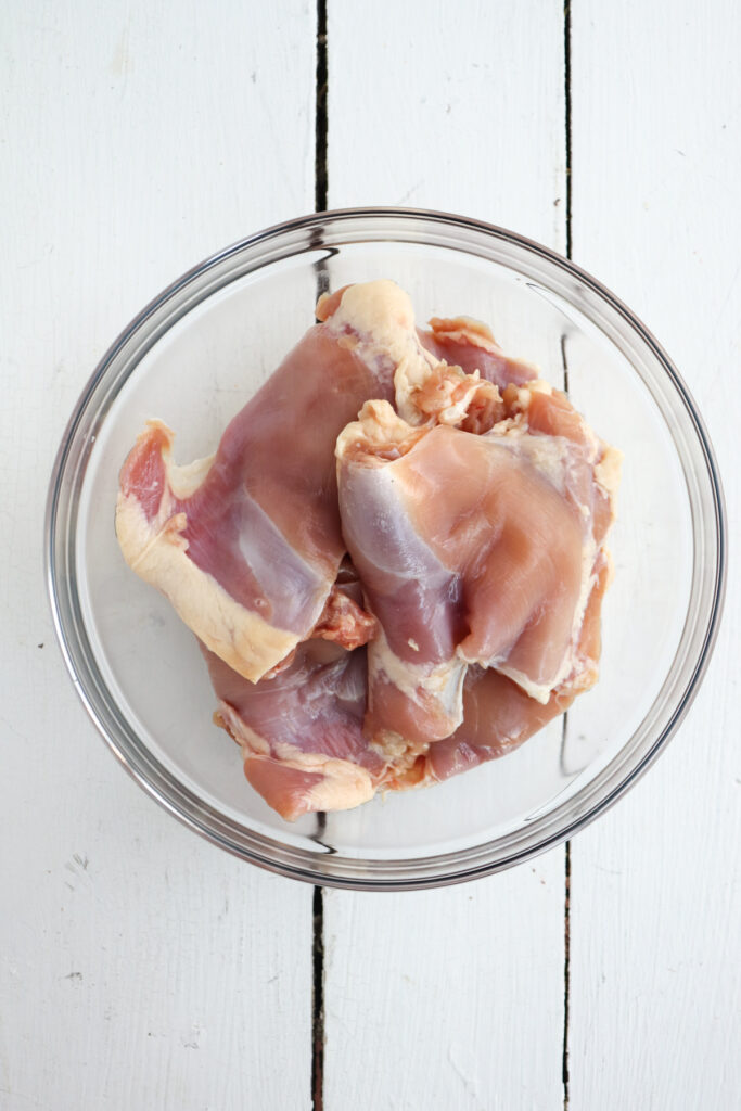 boneless skinless chicken thighs in a glass bowl