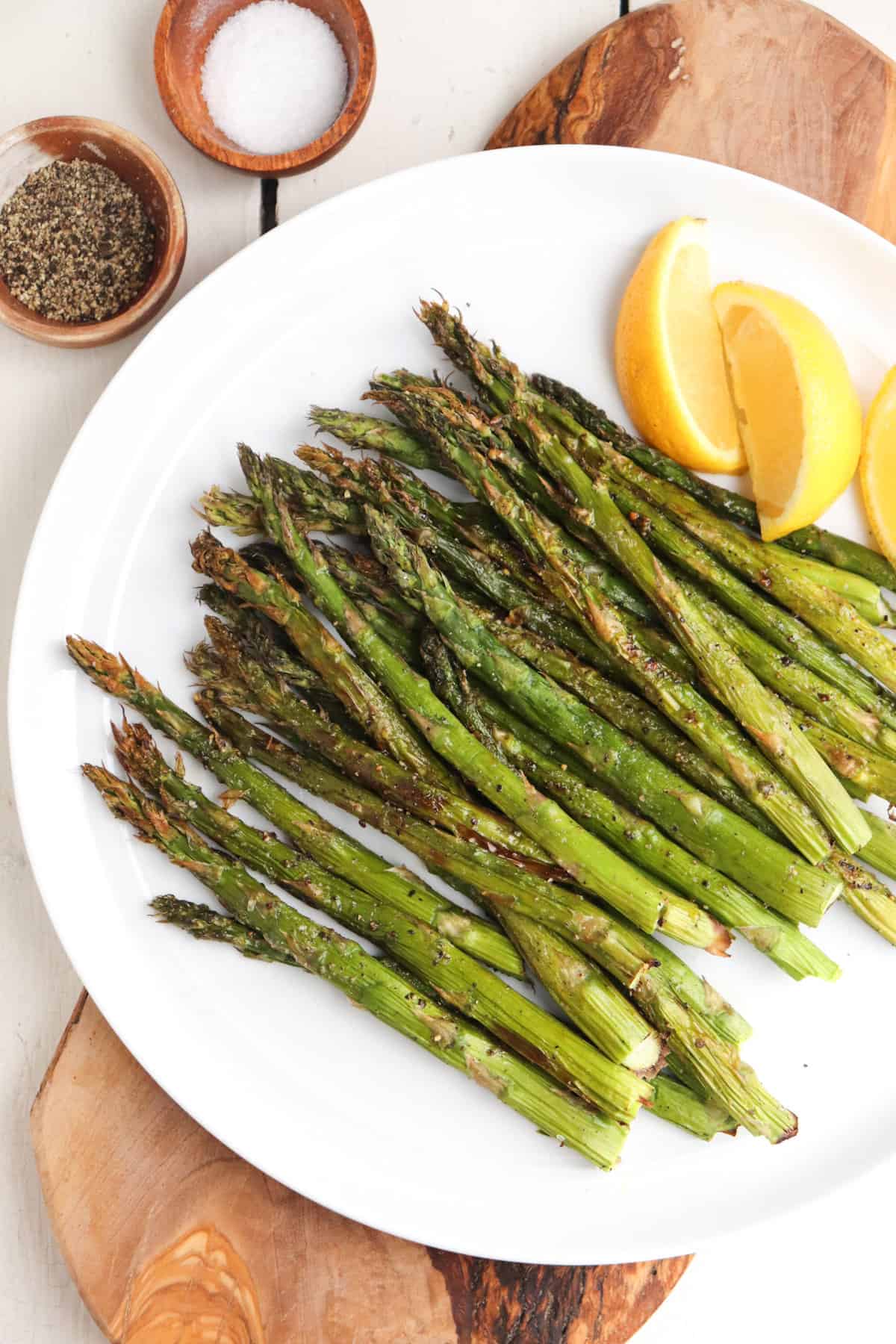 asparagus plated with lemon and salt and pepper. 