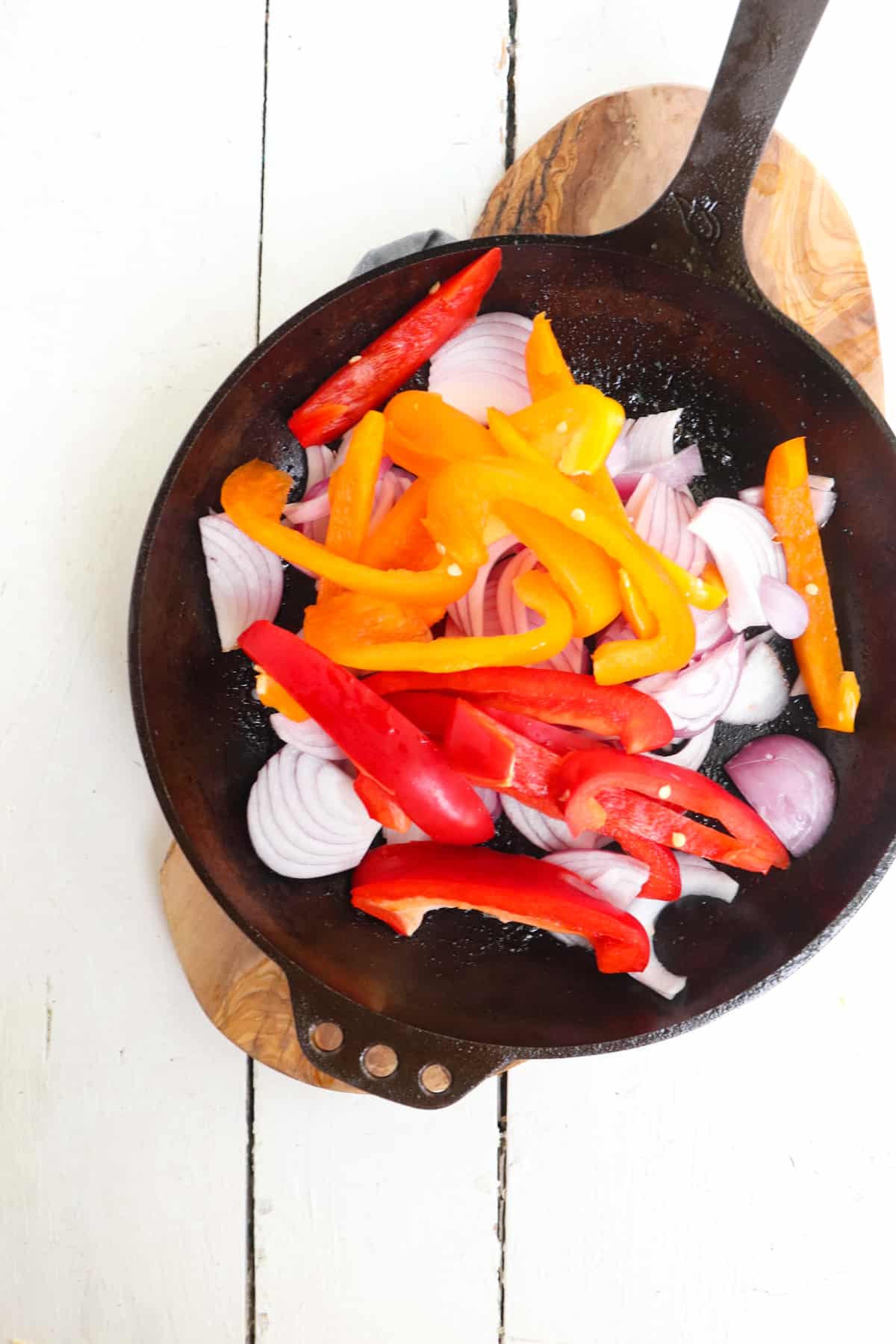 peppers and onions added to skillet.