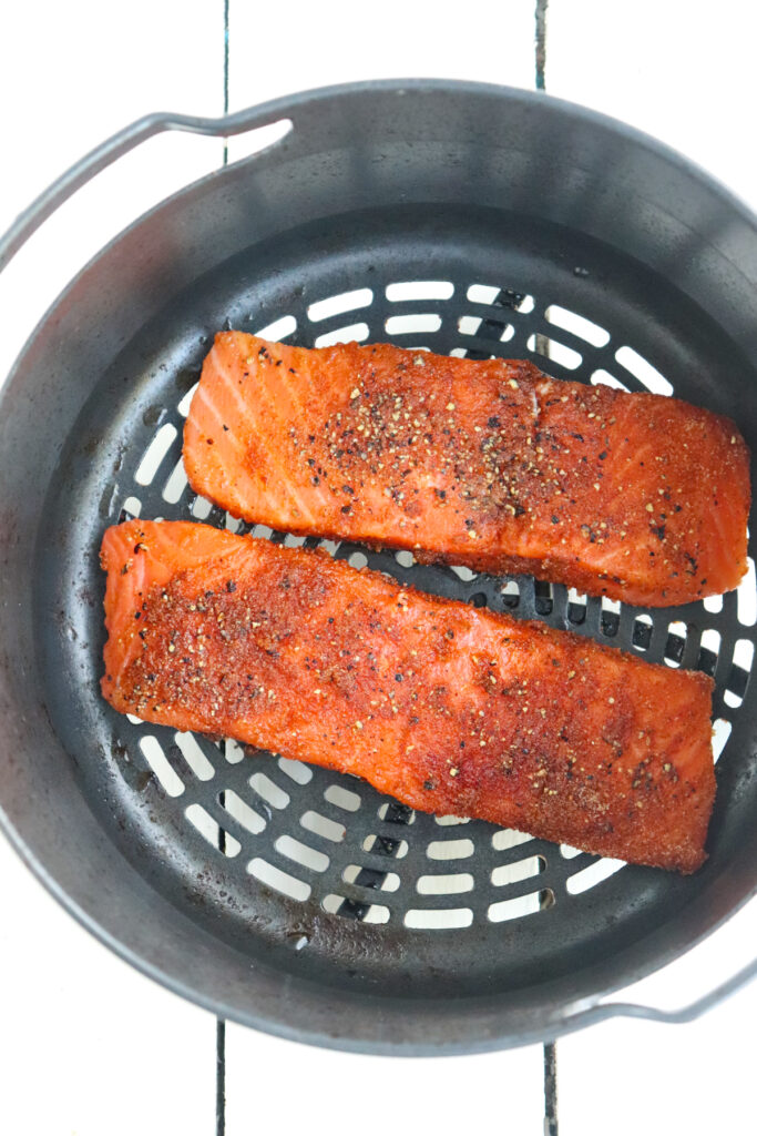 uncooked salmon filets in Ninja Foodi basket.